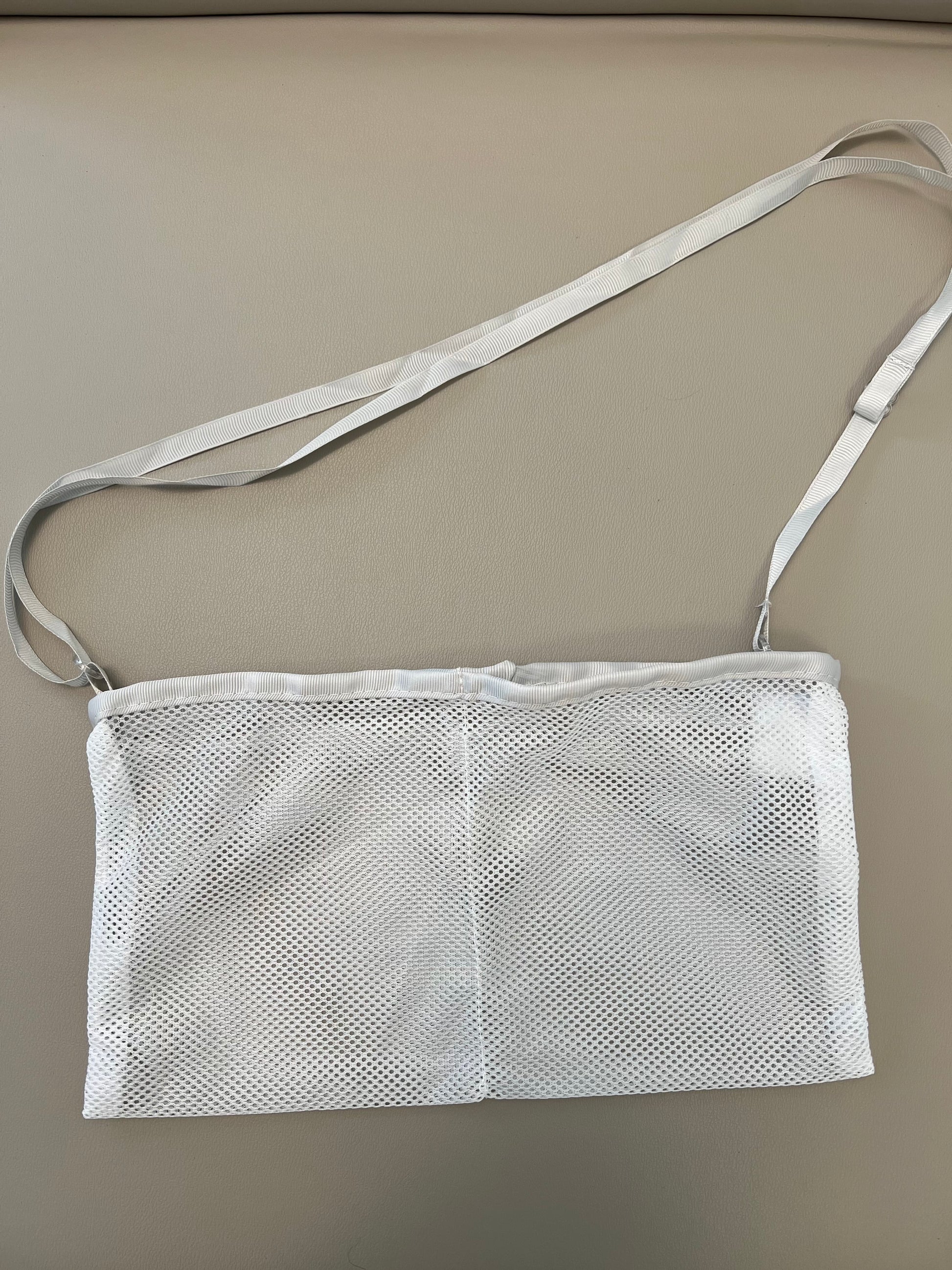 A photo of the shower drain holders from the mommy makeover recovery bundle laying on a gray table