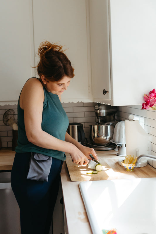 Woman recovering from mastectomy preparing food for herself